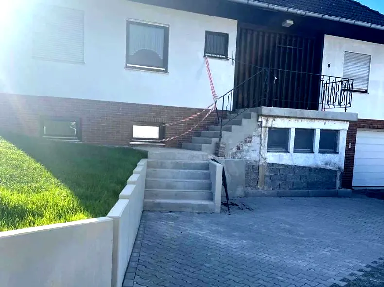 Neu gebaute Treppe, Winkelsteinmauer und Pflasterung vor einem Wohnhaus